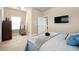 Bedroom features wall-mounted television, queen bed, plush carpet, and a walk-in closet at 3755 Lake Haven Way, Atlanta, GA 30349