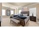 Spacious primary bedroom suite with a luxurious bed, tray ceilings, and large windows at 3755 Lake Haven Way, Atlanta, GA 30349