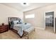 Bedroom with a wooden headboard, a queen sized bed, and an ensuite closet for storage at 3755 Lake Haven Way, Atlanta, GA 30349