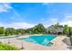 A community swimming pool with a pool house and mature trees at 3755 Lake Haven Way, Atlanta, GA 30349