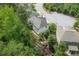 Aerial view of a home with a backyard including a patio, fire pit, and tiered garden beds at 572 Cresentry Brk, Smyrna, GA 30082