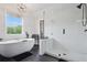 Sleek bathroom with standalone tub, glass-enclosed shower, black fixtures, and stylish lighting at 572 Cresentry Brk, Smyrna, GA 30082