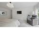 Bright bedroom featuring plush carpeting, a modern light fixture, and a comfortable gray recliner at 572 Cresentry Brk, Smyrna, GA 30082