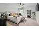 Serene bedroom featuring a large comfortable bed, ceiling fan, and a decorative shelving unit at 572 Cresentry Brk, Smyrna, GA 30082