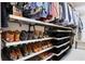Organized walk-in closet with multiple shelves for shoes, clothing, and storage containers at 572 Cresentry Brk, Smyrna, GA 30082