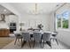 Elegant dining room featuring modern chandelier, neutral walls, hardwood floors, and large windows at 572 Cresentry Brk, Smyrna, GA 30082