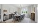 Bright dining room showcasing a modern table, elegant chandelier, and a large window overlooking greenery at 572 Cresentry Brk, Smyrna, GA 30082