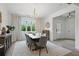 Dining room featuring modern table set, stylish chandelier, and a large window at 572 Cresentry Brk, Smyrna, GA 30082