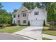 Charming two-story home featuring a brick facade, attached two-car garage, and a well-manicured lawn at 572 Cresentry Brk, Smyrna, GA 30082