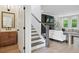 A view of the living room with stairs nearby, featuring modern decor and abundant natural light at 572 Cresentry Brk, Smyrna, GA 30082