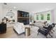 Bright living room with fireplace, contemporary decor, plush seating, and lots of natural light at 572 Cresentry Brk, Smyrna, GA 30082