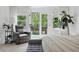 Bright main bedroom with plush furnishings, access to the outdoor deck, and hardwood flooring at 572 Cresentry Brk, Smyrna, GA 30082