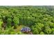 Aerial shot of a brick home with a lush forest surrounding it at 8032 Banks Mill Rd, Douglasville, GA 30135