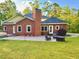 Spacious backyard patio area with comfortable seating, a cozy fire pit, and an inviting hot tub at 8032 Banks Mill Rd, Douglasville, GA 30135