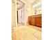 Spacious bathroom with a tile floor, vanity, large mirror, and access to another room at 8032 Banks Mill Rd, Douglasville, GA 30135
