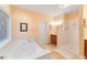 Well-lit bathroom with a soaking tub, a separate shower, and ample counter space at 8032 Banks Mill Rd, Douglasville, GA 30135