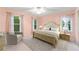 Bright, pink bedroom with a decorative bed frame, a seating area, and great natural light at 8032 Banks Mill Rd, Douglasville, GA 30135