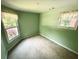 This bedroom offers ample natural light with a large window and features neutral carpeting at 8032 Banks Mill Rd, Douglasville, GA 30135