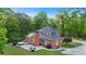 Brick home with a spacious backyard, featuring a patio, hot tub, fire pit, and lush greenery, perfect for outdoor living at 8032 Banks Mill Rd, Douglasville, GA 30135
