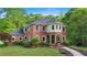 Beautiful brick two-story home featuring a landscaped yard and inviting arched entryway at 8032 Banks Mill Rd, Douglasville, GA 30135