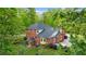 Beautiful brick home surrounded by lush greenery, with a well-maintained lawn and mature trees at 8032 Banks Mill Rd, Douglasville, GA 30135