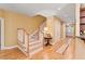 Welcoming foyer featuring hardwood floors, a staircase with white railings, and stylish decor at 8032 Banks Mill Rd, Douglasville, GA 30135
