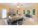 Bright bedroom with multiple windows, neutral tones, ceiling fan, and plenty of natural light at 8032 Banks Mill Rd, Douglasville, GA 30135