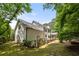 Spacious, grassy backyard surrounded by lush trees and fencing, perfect for outdoor activities at 2180 Dunwoody Heritage Dr, Atlanta, GA 30350