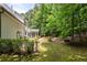 Large, manicured backyard featuring an expansive grassy area surrounded by mature trees at 2180 Dunwoody Heritage Dr, Atlanta, GA 30350