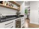 Stylish bar area with wine storage, marble countertop, and hardwood floors at 2180 Dunwoody Heritage Dr, Atlanta, GA 30350