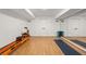 Brightly lit basement gym with light wood flooring and mirrored wall for exercise at 2180 Dunwoody Heritage Dr, Atlanta, GA 30350