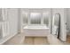 Modern bathroom with a freestanding tub, frosted windows, and a sleek faucet, offering a spa-like experience at 2180 Dunwoody Heritage Dr, Atlanta, GA 30350