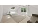 Bright bedroom featuring a skylight, a large window, a bed with white linens, and a comfortable couch at 2180 Dunwoody Heritage Dr, Atlanta, GA 30350