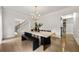 Bright dining room featuring modern light fixture, light walls, and access to staircase at 2180 Dunwoody Heritage Dr, Atlanta, GA 30350