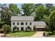Charming two-story home with manicured lawn, mature trees, and attached two-car garage at 2180 Dunwoody Heritage Dr, Atlanta, GA 30350