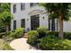 Close up of front entrance with lush greenery and curved walkway, framed by verdant landscaping at 2180 Dunwoody Heritage Dr, Atlanta, GA 30350