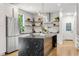 Modern kitchen features a large island with a stunning black marble countertop and stainless steel appliances at 2180 Dunwoody Heritage Dr, Atlanta, GA 30350