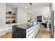 Kitchen with large island, stainless steel appliances and view of the open concept living room at 2180 Dunwoody Heritage Dr, Atlanta, GA 30350