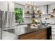 Bright kitchen features a marble-topped island, stainless steel appliances and black hardware at 2180 Dunwoody Heritage Dr, Atlanta, GA 30350