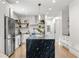 Modern kitchen with stainless steel appliances, marble island, and open shelving at 2180 Dunwoody Heritage Dr, Atlanta, GA 30350