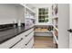 Well-organized pantry featuring ample shelving, black countertops, and a window for natural light at 2180 Dunwoody Heritage Dr, Atlanta, GA 30350