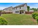 Expansive backyard with a lush lawn, privacy fence, and an open patio area for outdoor living at 221 Hampton Station Blvd, Canton, GA 30115
