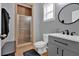 Well-lit bathroom with a tiled shower, a sleek vanity, and a modern round mirror at 221 Hampton Station Blvd, Canton, GA 30115