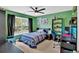 Vibrant bedroom with green walls, a ceiling fan, a window, and a comfortable study corner at 221 Hampton Station Blvd, Canton, GA 30115
