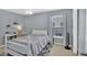 Calm bedroom with a full-sized bed, a workstation, a window, and neutral decor at 221 Hampton Station Blvd, Canton, GA 30115