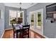 Cozy dining area with hardwood floors, pendant lighting, and access to the backyard through double doors at 221 Hampton Station Blvd, Canton, GA 30115
