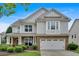 Charming two-story home featuring a brick-and-siding facade and a welcoming covered front porch at 221 Hampton Station Blvd, Canton, GA 30115