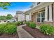 Inviting walkway to a home with a brick facade and landscaped garden featuring lush green bushes at 221 Hampton Station Blvd, Canton, GA 30115