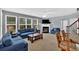 Comfortable living room featuring plush blue seating, a fireplace, and large windows for ample natural light at 221 Hampton Station Blvd, Canton, GA 30115