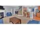 Comfortable living room with a fireplace, blue seating, and an open view to the kitchen and staircase at 221 Hampton Station Blvd, Canton, GA 30115